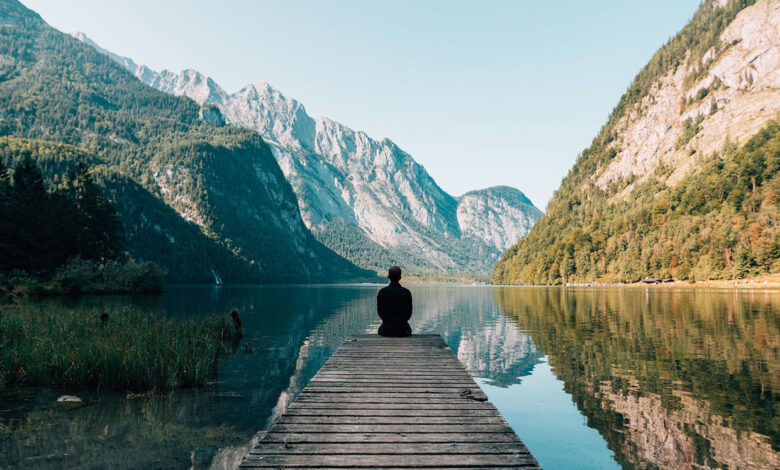 Man sitting on grey dock
